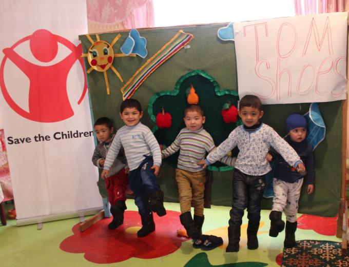 Children of Early Childhood Development Centre are demonstrating their new shoes, Kara-Su district of Osh province