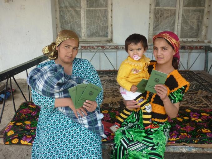 A mother showing 5 new-received birth certificates for her children