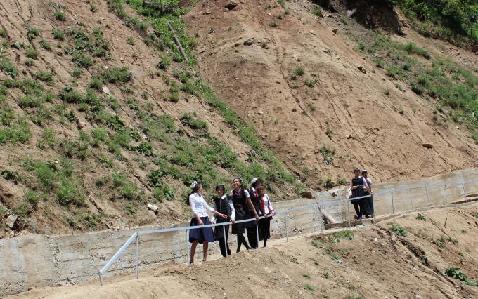 Local school girls use the new hand railing constructed under the project
